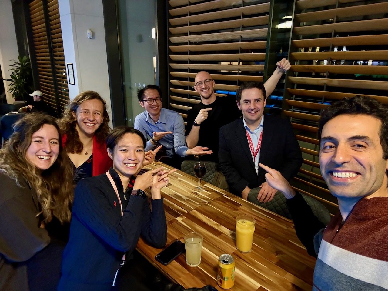 The lab celebrating with Alasdair Mackay after his viva, everyone pointing at the new doctor.
