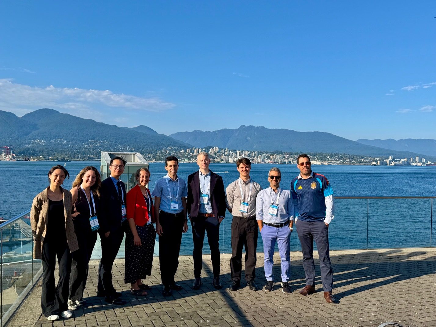 The HEAD Lab group on the waterfront in Vancouver with the North Shore mountains behind, during the World Congress of Biomechanics 2026.